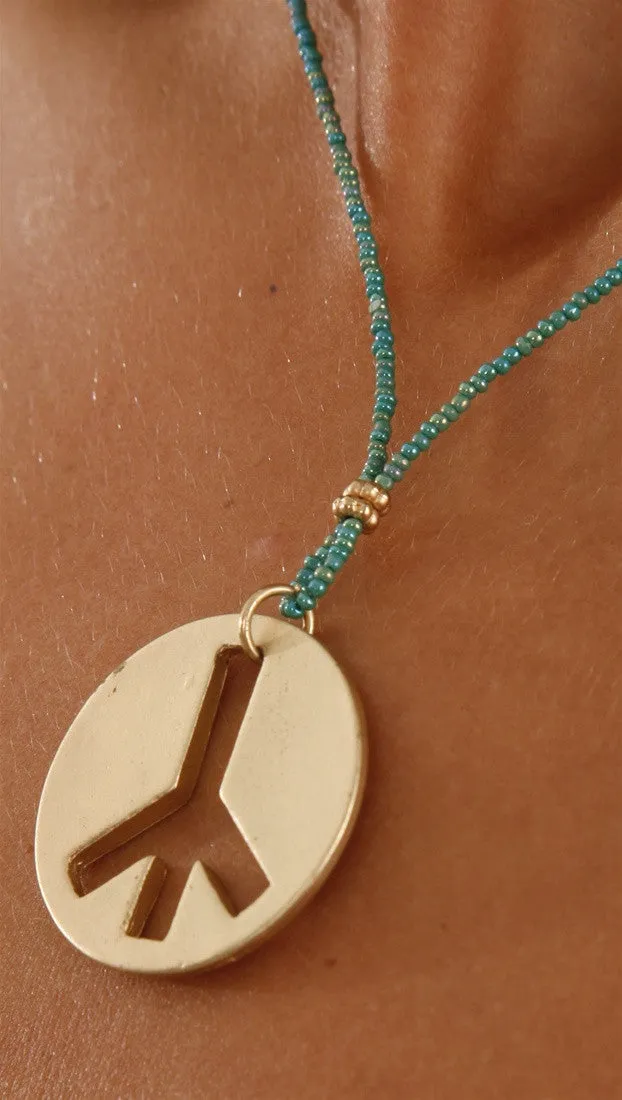 Gold Brushed Peace Charm Necklace on Teal Beaded Chain